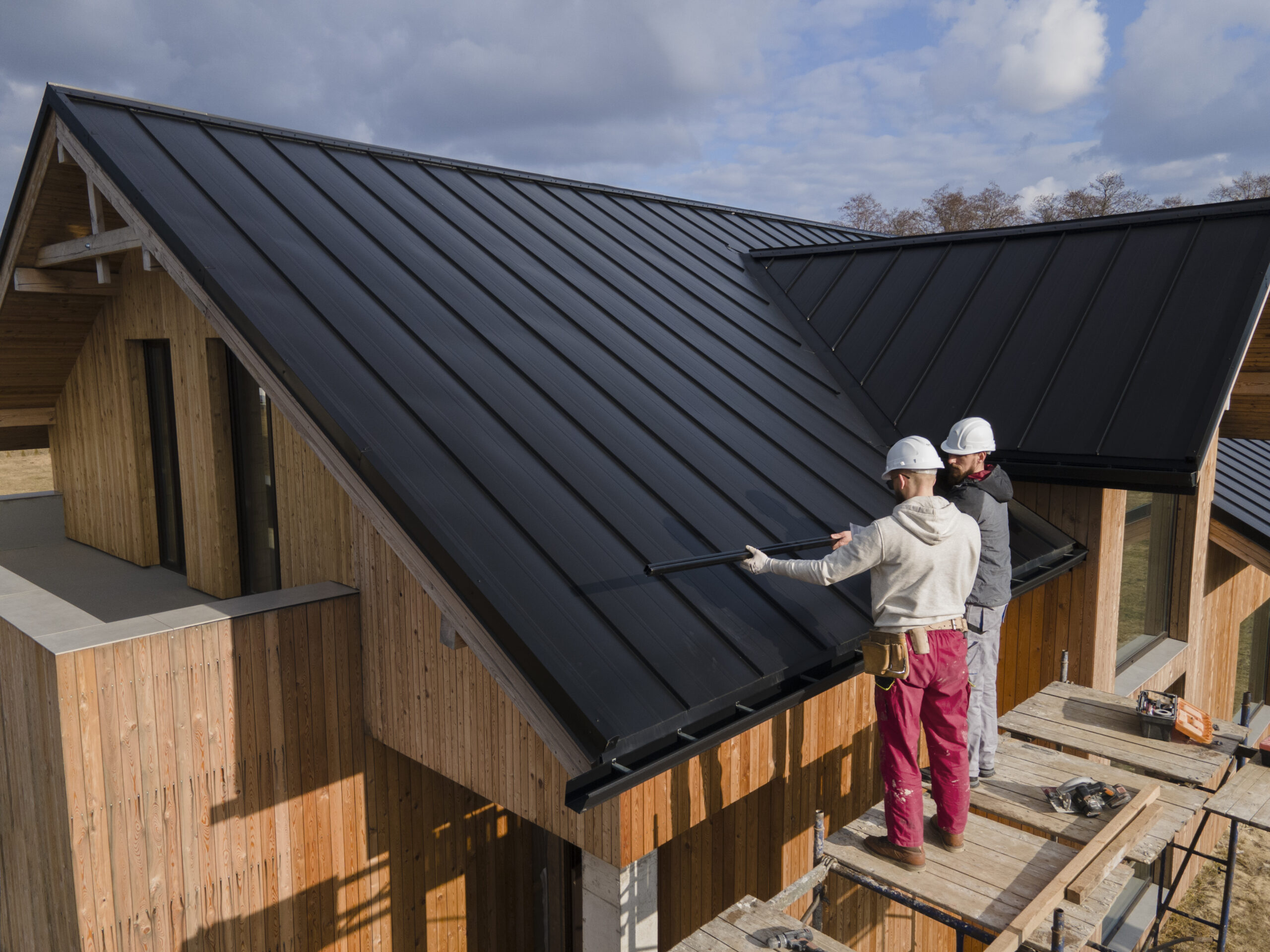 full shot roofers working together with helmets scaled 1.jpg