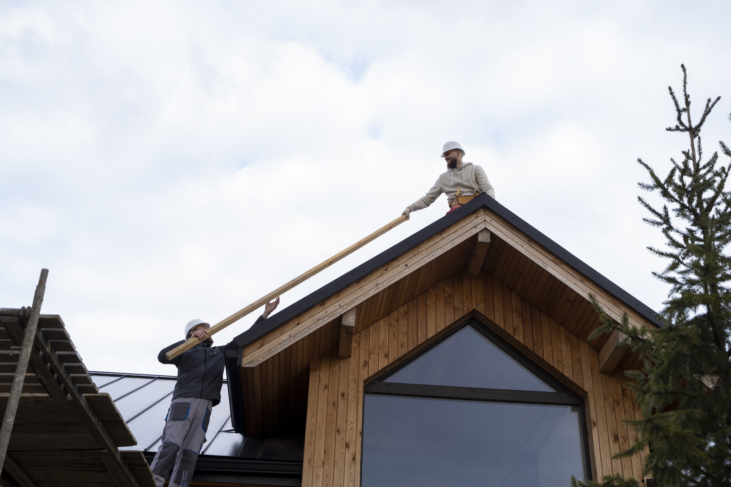 long shot men working roof scaled 1.jpg